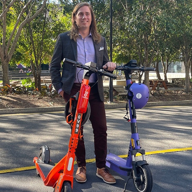 Dr Richard Buning with rideshare scooters