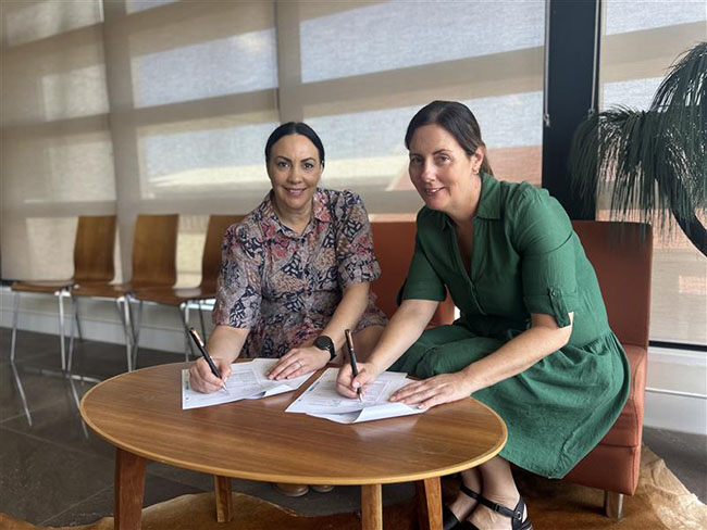 Lisa Ruhanen (UQ) and Renita Anderson (Triple A) signing the partnership agreement.