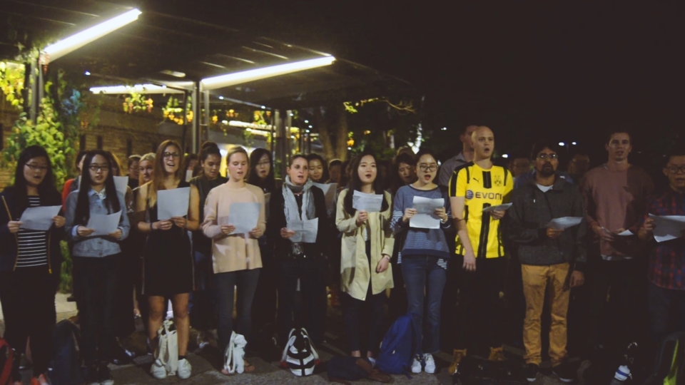 UQ Business School students sing to passers by as part of their course on wise leadership