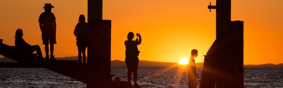 Tourist enjoying sunset on NSI