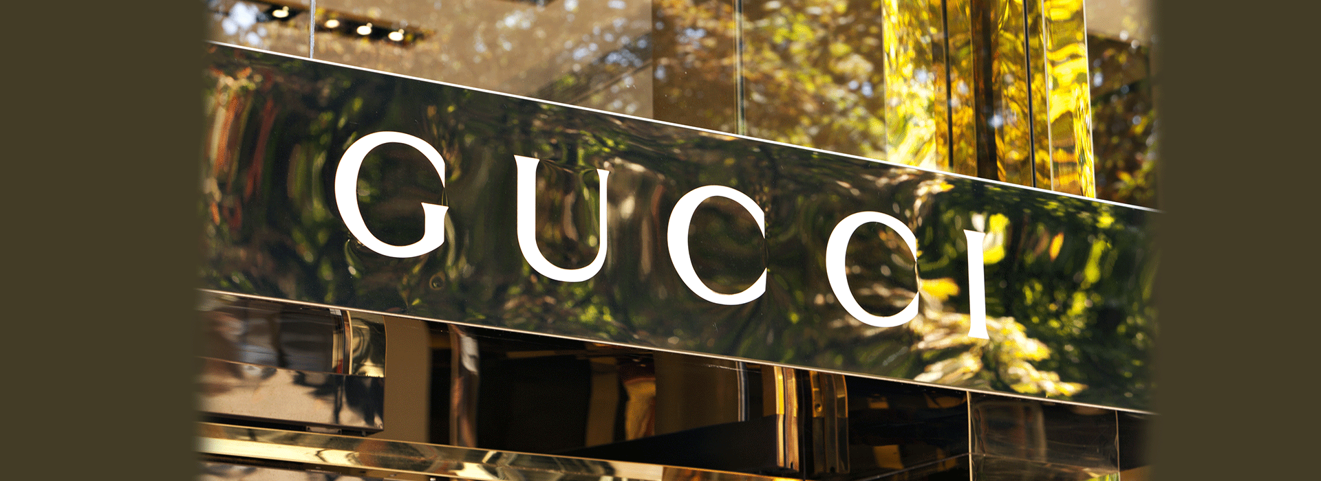 golden Gucci sign on a storefront 