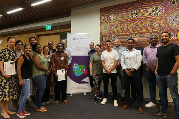 Participants of the UQ Carbon Literacy Program standing in a group holding their certificates