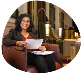 Soumya Nair, MBA graduate sitting on chair in UQ Brisbane City Campus 