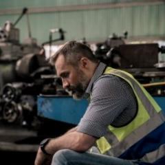 Workplace health and safety image, man in industrial location with high-vis