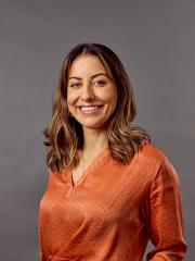 Francine Muller standing in business attire for professional photoshoot. 