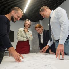 people standing around a project working.