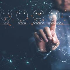 Businessman pressing smiley face emoticon on virtual touch screen. Customer service evaluation concept.