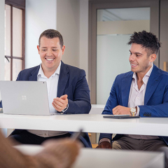 Two MBA students talking with laptop in UQ Brisbane City campus 