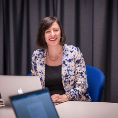 MBA student Athena in front of laptop in UQ classroom 