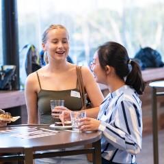 students socialising at a table. 