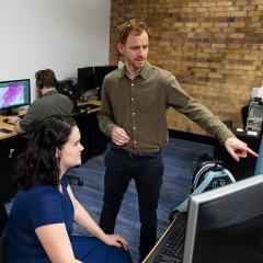 A male and female looking at computer screens