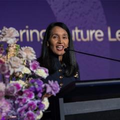 Raynuha Sinnathamby speaking at podium