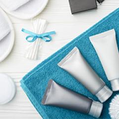 Hotel soaps and other single use items laid out for a guest.