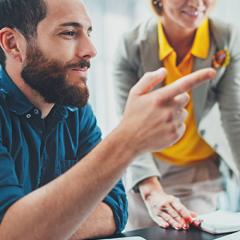 Two professionals communicating in a boardroom