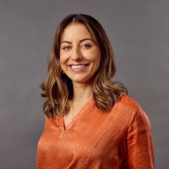 Francine Muller standing in business attire for professional photoshoot. 